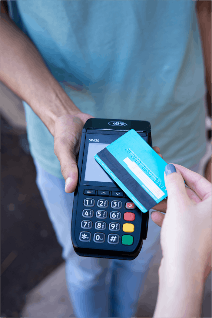 home-hero Close-up of hands performing contactless payment with credit card in Durban, South Africa.